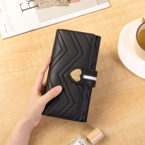 Women's black long wallet with V-quilted pebble leather and gold heart buckle