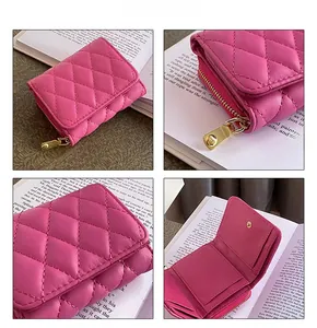 Detail view of pink quilted trifold wallet featuring card slots and gold hardware