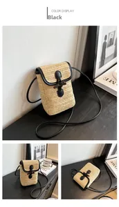 Detail of straw woven crossbody bag with black leather trim and vintage metal buckle