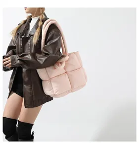 Detailed side view of a pink quilted puffer tote bag with soft padded texture and handles