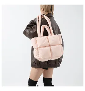 Chic pink quilted puffer tote bag with puffy square texture and matching shoulder straps