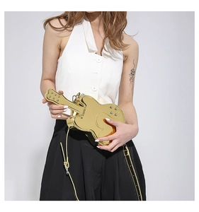 Detailed view of creative golden violin shaped crossbody bag with metallic mirror finish