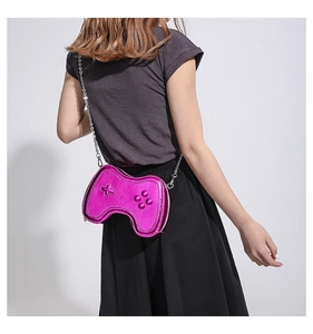 Detail of rose red gamepad crossbody bag with metallic finish and silver chain strap