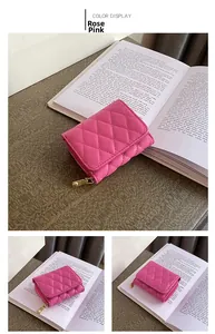 Close-up of rose pink quilted card holder with gold zipper on vintage book background