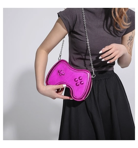 Detail of metallic purple game controller bag with silver chain strap on model