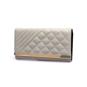Grey quilted long wallet for women with elegant gold metal trim and tri-fold design