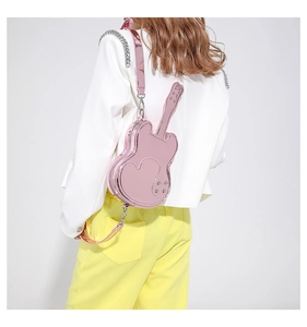Pink violin-shaped crossbody bag featuring metallic patent leather and heart texture details