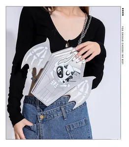 Detail of silver coffin-shaped crossbody bag with bat wings and cartoon devil print