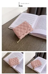 Detail of pink quilted mini wallet with gold zipper and stylish diamond stitch texture