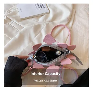 Interior view of silver dinosaur-shaped crossbody bag showing storage for sunglasses