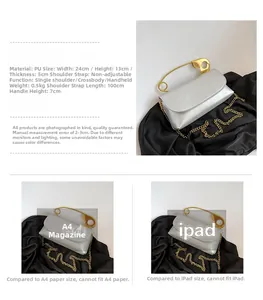 Detail view of silver PU flap bag with golden pin buckle and chain strap on black satin