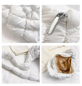 Detailansicht der weißen gesteppten Puffer-Tasche mit Nylonstruktur und Metallreißverschluss