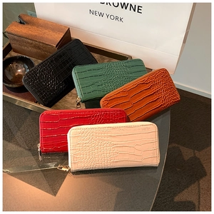 Detailed macro view of crocodile pattern textures on long zip-around wallets in five colors