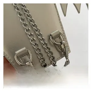 Macro shot of silver metal chain strap and D-ring on the geometric gray crossbody bag