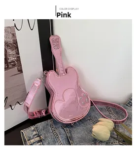 Close-up of pink violin shaped crossbody bag featuring heart stitching and metallic studs