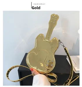 Detail of gold guitar-shaped crossbody bag with mirror PU finish and heart stitching