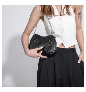 Detailed view of creative black gamepad-shaped crossbody bag with relief buttons and chain