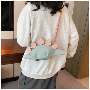Detailed back view of a cute green leather dinosaur crossbody bag with pink triangular scales