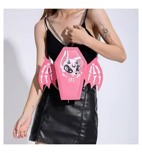 Detail view of pink coffin crossbody bag with gothic devil rabbit print and bone wings