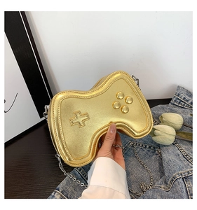Detail of creative game controller shaped crossbody bag in metallic gold finish