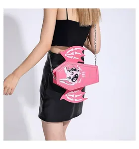 Detailed side view of pink coffin shaped shoulder bag with bat wings and silver chain
