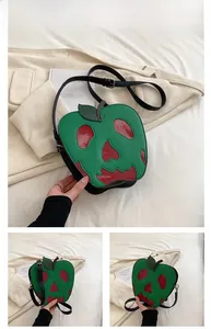 Close-up of poison apple shoulder bag with red skull patch and green lychee grain leather