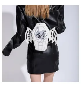 Detail of white coffin shaped bag with bat wings and chain strap on black outfit