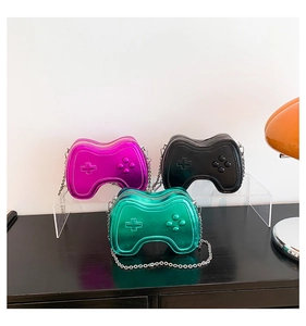 Detailed view of creative game controller purses in metallic green, black, and rose red