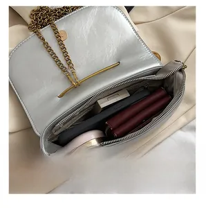 Interior view showing the storage capacity for makeup and phone in a silver chain bag