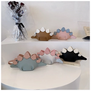 Collection of mini dinosaur crossbody bags in various colors on a white display stand