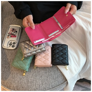 Detailed interior of quilted card wallet showing multiple slots and zip closure in five colors