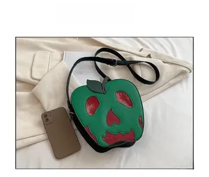 Close-up of the creative poison apple shaped crossbody bag with red melting drip detail