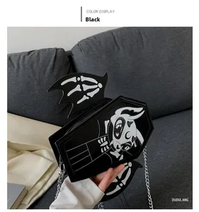 Detailed view of gothic coffin bag with cartoon devil print and bat wing decorations