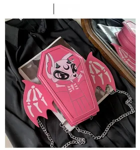 Pink coffin-shaped gothic crossbody bag with bat wings and a silver chain strap
