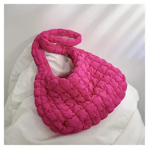 Macro detail of magenta quilted cloud tote bag texture and seamless zipper closure