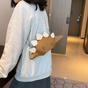 Creative dinosaur shaped crossbody bag in brown pebble leather with white accents