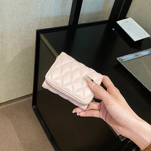 Pink quilted leather small crossbody bag with diamond stitching and top zipper closure