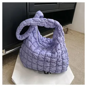 Detail of lilac quilted puffer bag with a unique handcrafted knotted handle design