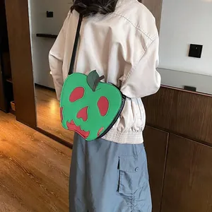 Detailed view of apple-shaped crossbody bag featuring a red skull dripping pattern design