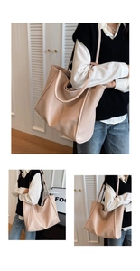 Detailed view of large beige tote bag with textured leather and minimalist shoulder strap