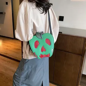 Detail of poisonous apple crossbody bag with skull cutout and fine PU leather strap