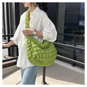 Macro shot of grass green quilted shoulder bag showing the fluffy texture and nylon fabric