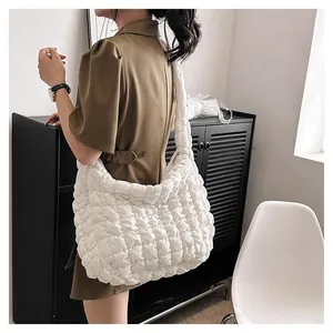 Detail view of large white quilted tote bag featuring a soft cloud-like pleated texture