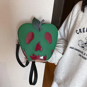 Detail of creative green skull apple shoulder bag with textured faux leather finish