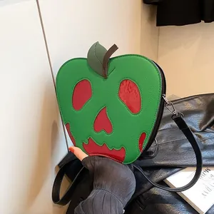 Detail of poisonous apple crossbody bag with skull face and green lychee texture