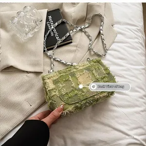 Close-up of green and beige quilted plaid shoulder bag featuring fringed edge texture