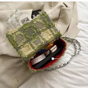 Detailed interior of green checkered tweed crossbody bag showing daily essentials storage