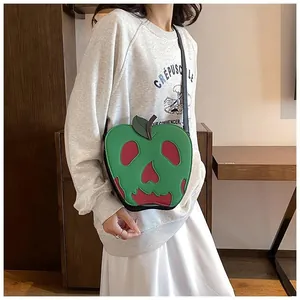 Detail of poisonous apple shoulder bag with red skull cutout design for Halloween style