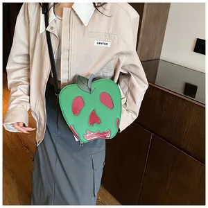 Detail of creative green ghost apple shoulder bag worn by model for Halloween