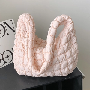 Pink quilted cloud tote bag with puffy stitching on display, large capacity shoulder bag